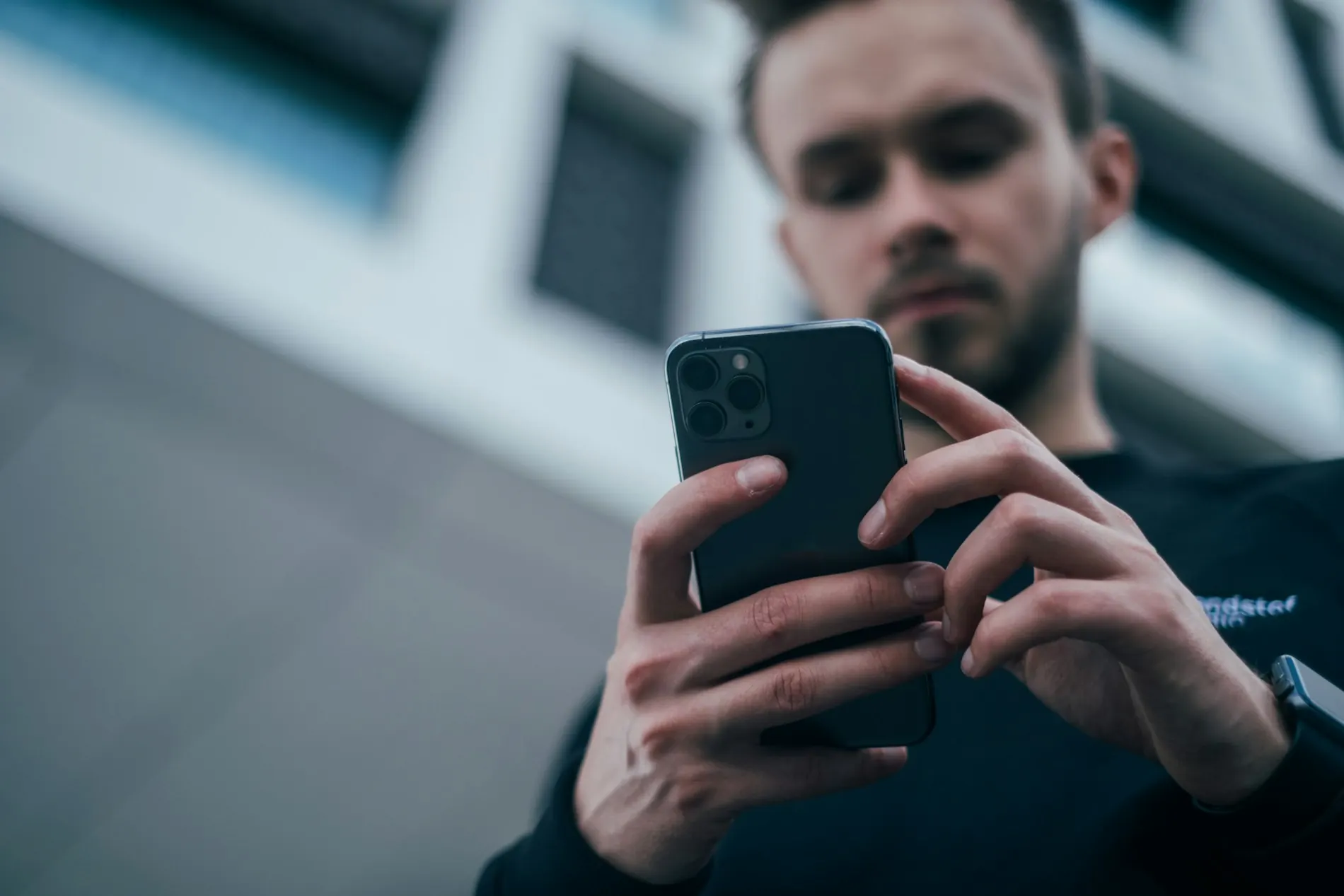 Mann sucht etwas auf seinem Smartphone